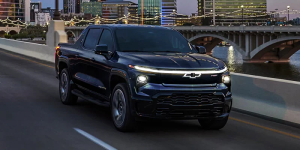 A front photo of a 2025 Silverado EV driving down a highway near Wind Gap, PA